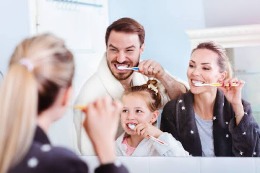 Happy beautiful family having fun enjoying taking care of hygiene